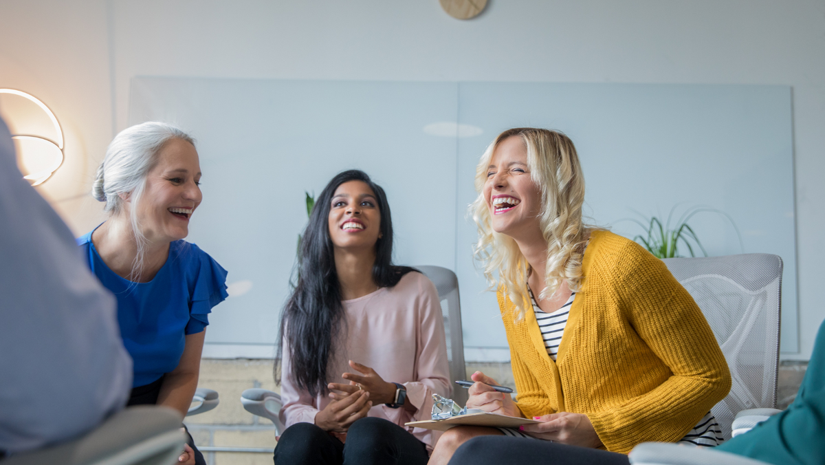 3 women chatting and laughing inside