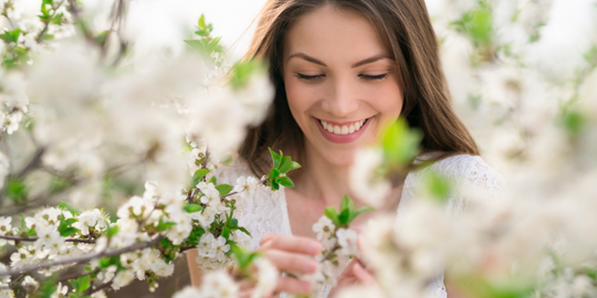 Smiling woman in spring blossom