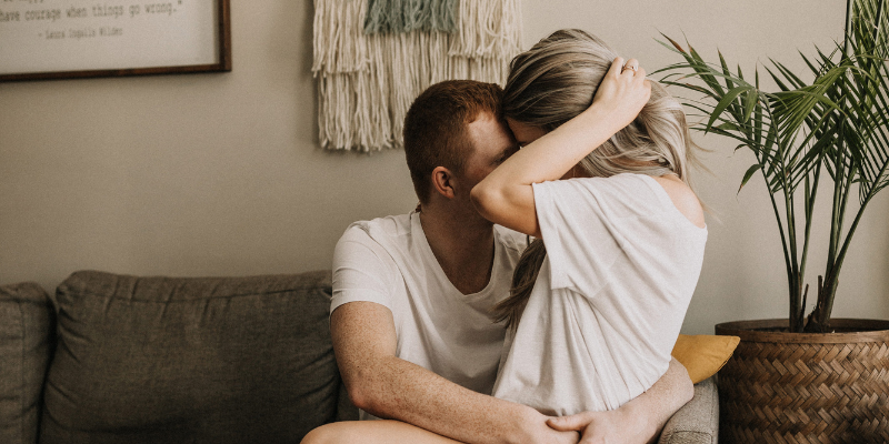 Women sat on male partners lap