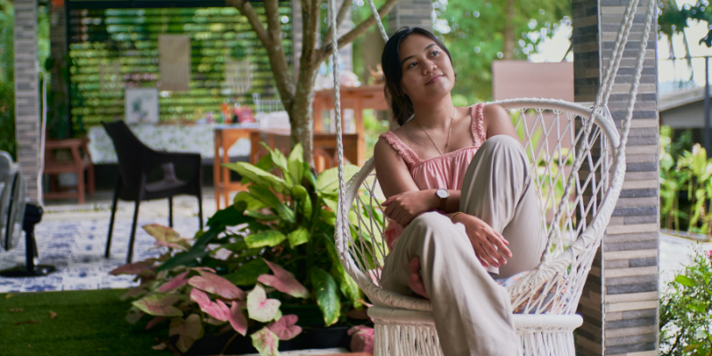 women sat in nature thinking