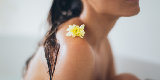 Close-up of womens shoulder sat in bath