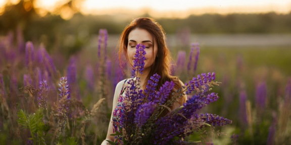 Woman smelling flowers in meadow
