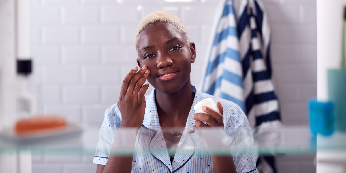 woman looking in the mirror thinking about cervical screening appointment