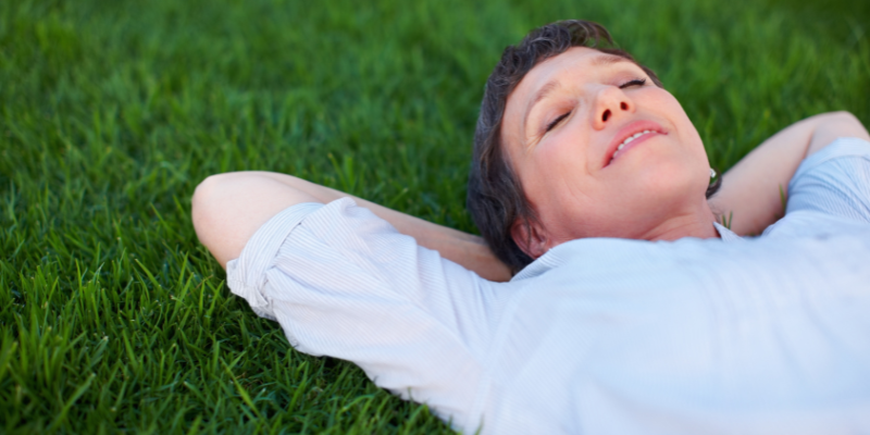 Satisfied women lying in grass