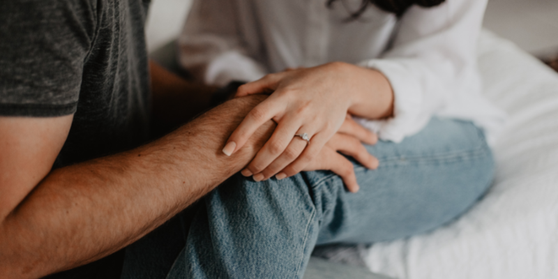 Couple holding hands discussing sex after cancer