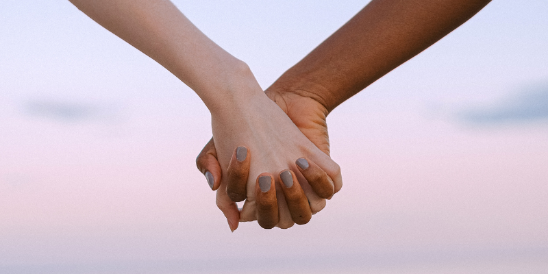 Women holding hands supporting ovarian cancer diagnosis