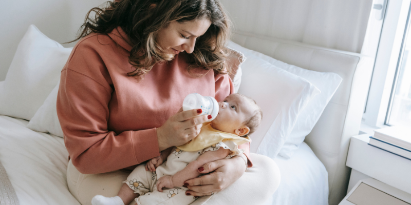 women feeding newborn baby